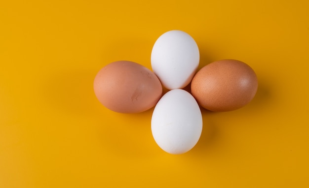 Foto uova di gallina isolate su giallo