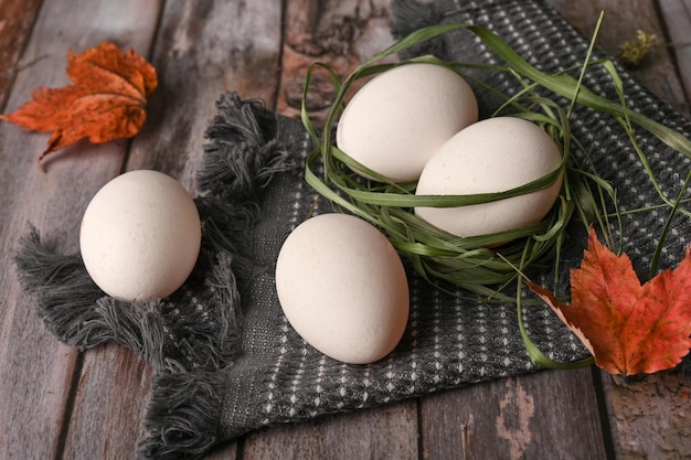 Chicken eggs lie on a wooden table in the kitchen