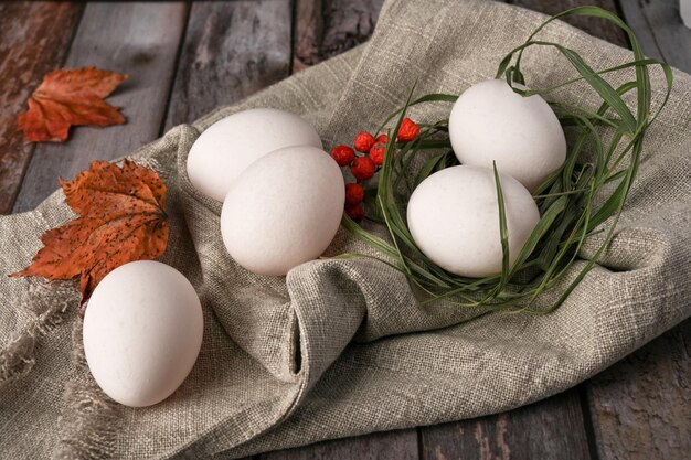 Chicken eggs lie on a wooden table in the kitchen