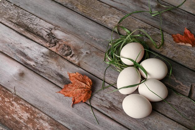 Chicken eggs lie on a wooden table in the kitchen