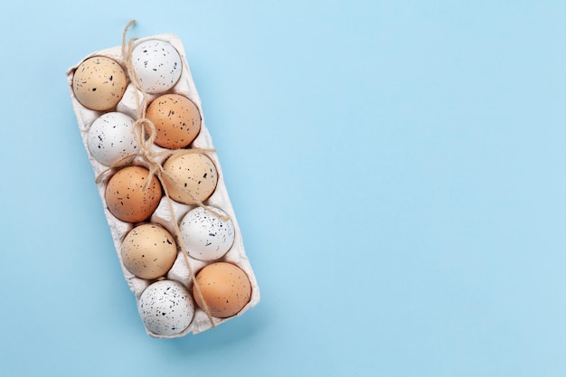 Chicken eggs pack on blue table