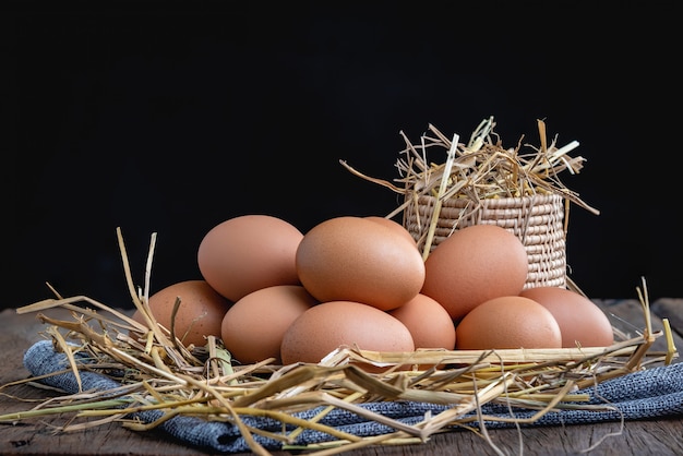 Chicken eggs placed on a straw 