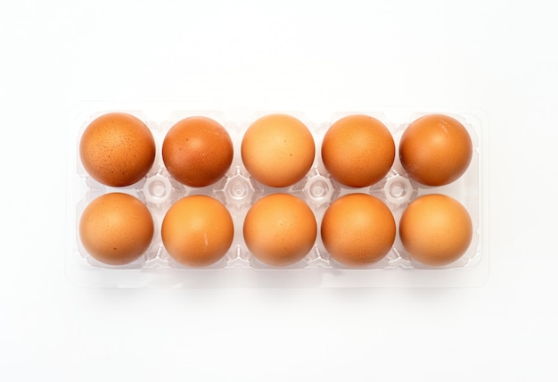 Chicken eggs in plastic package on white background.