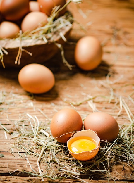 Chicken eggs in a plate on a wooden table