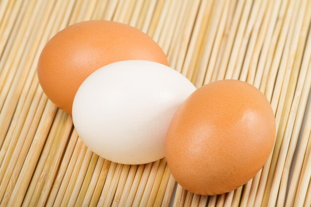 Chicken eggs stacked on the wooden table