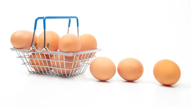 Chicken eggs in a supermarket grocery basket on a white background.