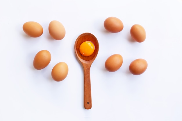 Chicken eggs with yolk on white background.