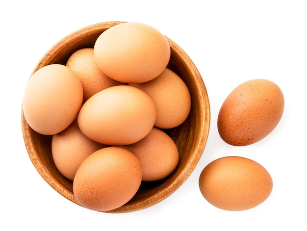 Chicken eggs in a wooden plate  The view of the top.