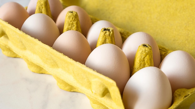 Chicken eggs in yellow cardboard egg tray