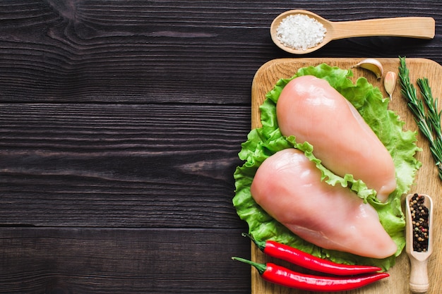 Chicken fillet on a cutting board. Top view.