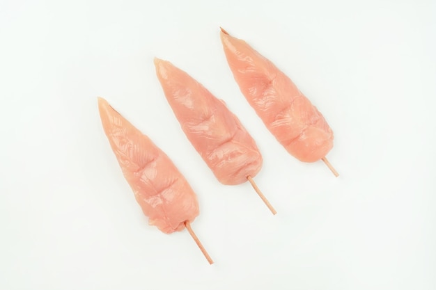 Chicken fillet inner skewersraw chicken breast filletsfood concepttop viewskewers from raw chicken m