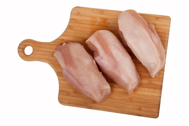 Photo chicken fillet on kitchen board