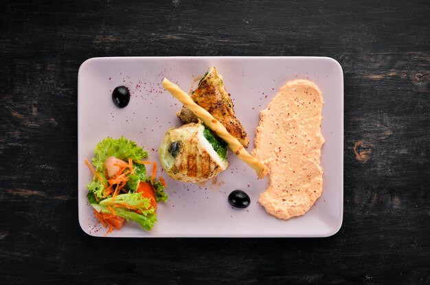 Chicken fillet with spinach cheese and mushrooms On a wooden background Top view Free space for your text