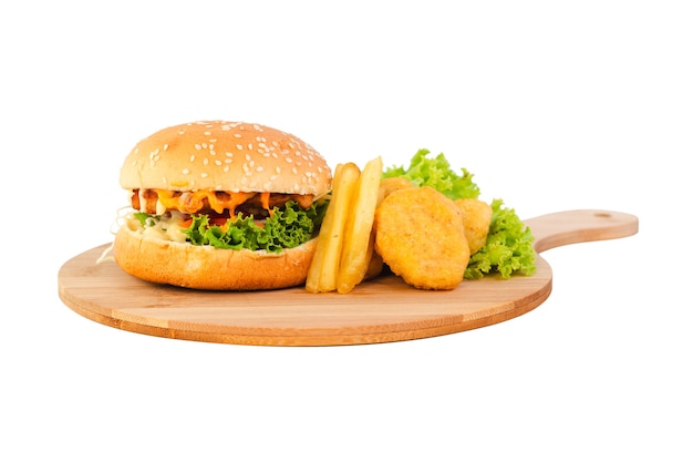 Chicken hamburger with nuggets and french fries on a wooden plate