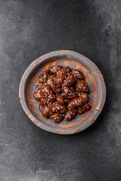 Chicken hearts fried in soy sauce with salt and spices in a plate