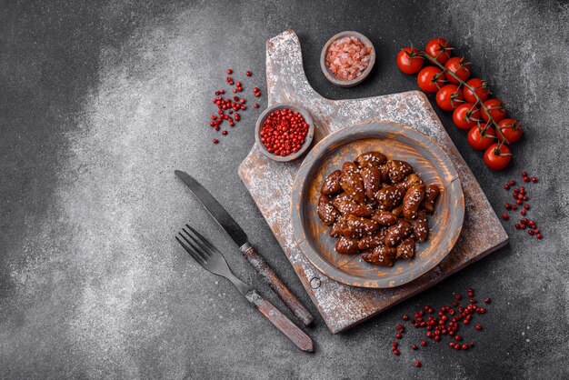 Chicken hearts fried in soy sauce with salt and spices in a plate