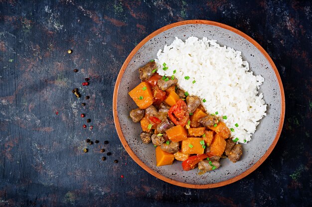 Chicken hearts with pumpkin and tomatoes in tomato sauce. 