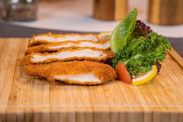 Chicken Katsu with slicesxAlemons and tomatoes