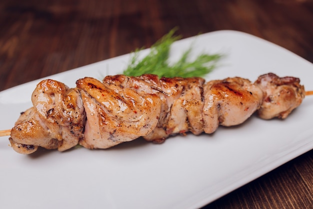 Chicken kebabs on wooden background