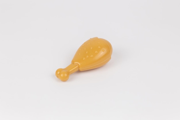 Chicken leg plastic toy child on a white background