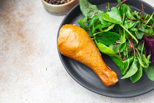 Chicken leg and salad leaves mix green healthy meal food snack on the table copy space food