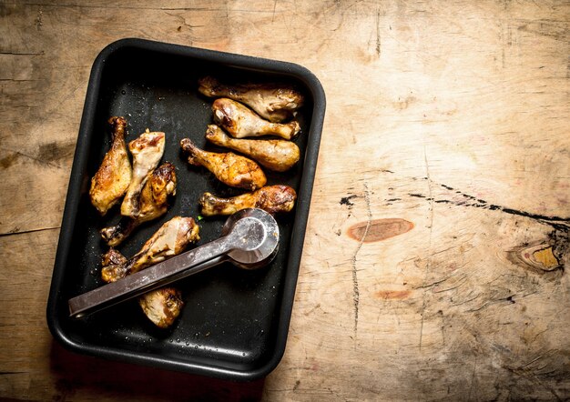 Chicken legs on the baking sheet.