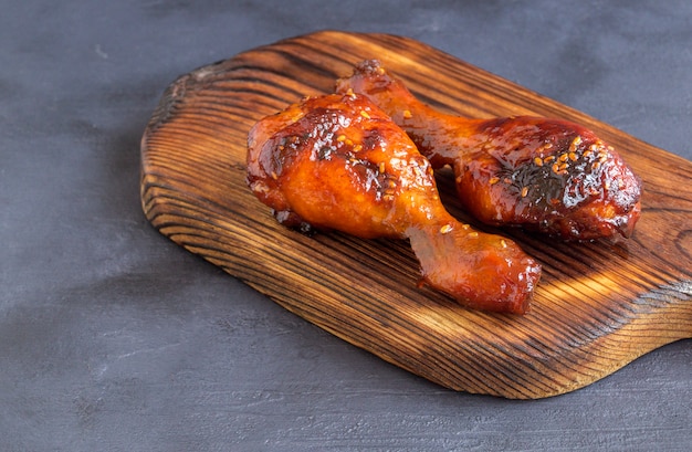 Chicken legs fried in sweet and sour sauce with sesame seeds