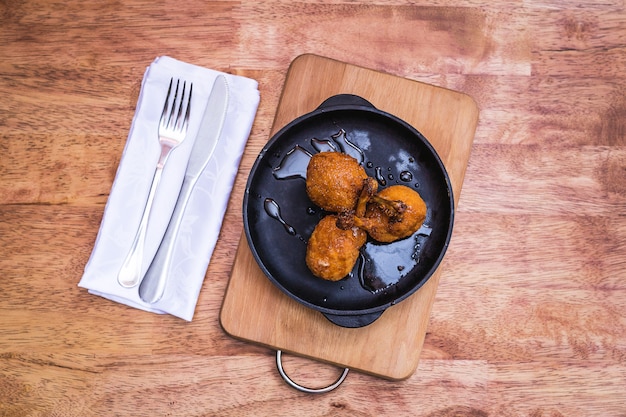 Chicken legs in an iron frying pan