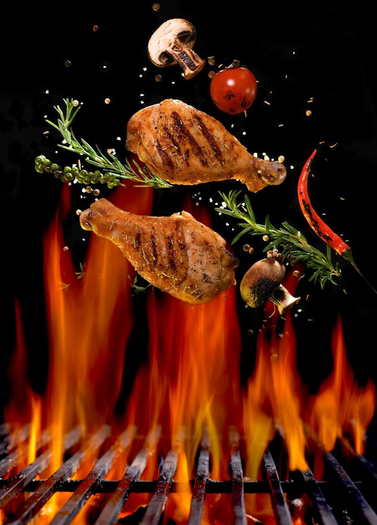 Photo chicken legs and spicy ingredients flying above flaming red barbeque grill