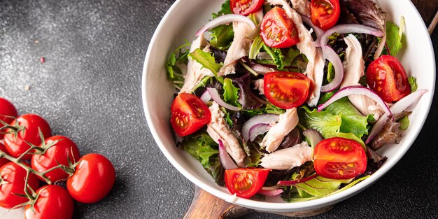 chicken meat salad tomato, green lettuce, onion healthy meal food snack on the table copy space