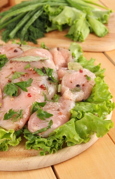 Chicken meat on wooden boardherbs and spices closeup