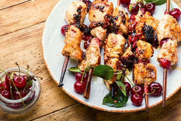 Chicken meat on wooden skewers in cherry marinade