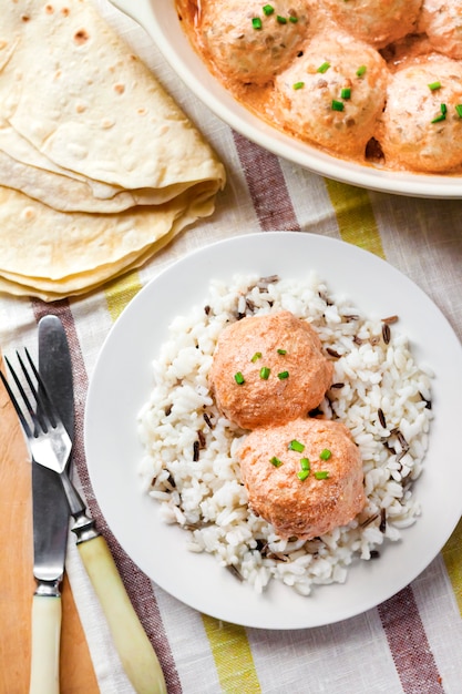 Chicken meatballs in creamy tomato sauce with rice