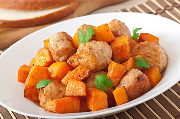 Chicken meatballs with a garnish cooked of baked pumpkin