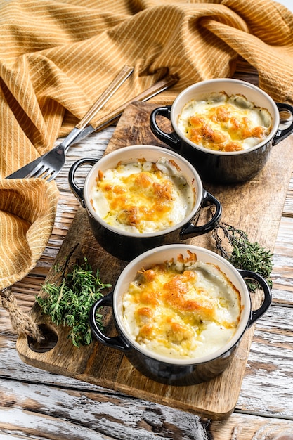 Chicken and  mushroom casserole in a clay pot. White background. Top view.