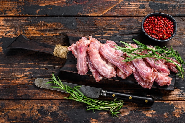 まな板の上の鶏の首の肉。木製の背景。上面図。