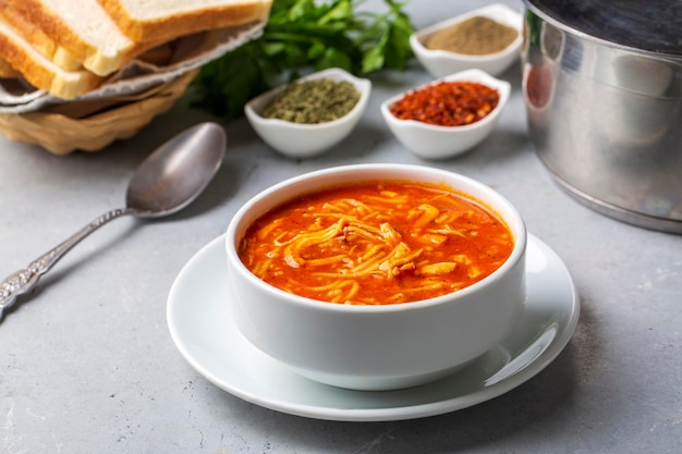 Chicken noodle soup with tomato. Turkish name; Domatesli tavuklu sehriye corbasi