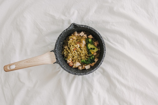 Chicken noodle with broccoli served in a boiler