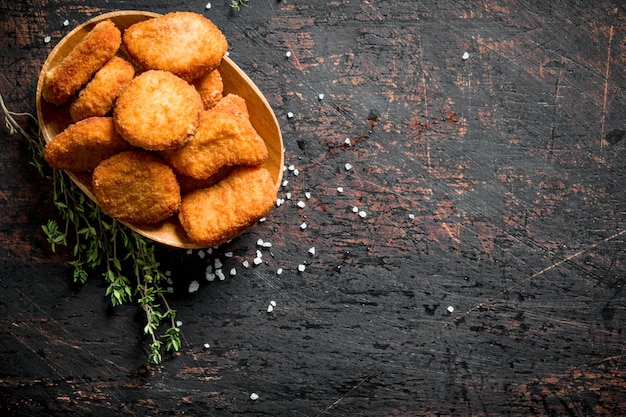 Chicken nuggets in a bowl with thyme