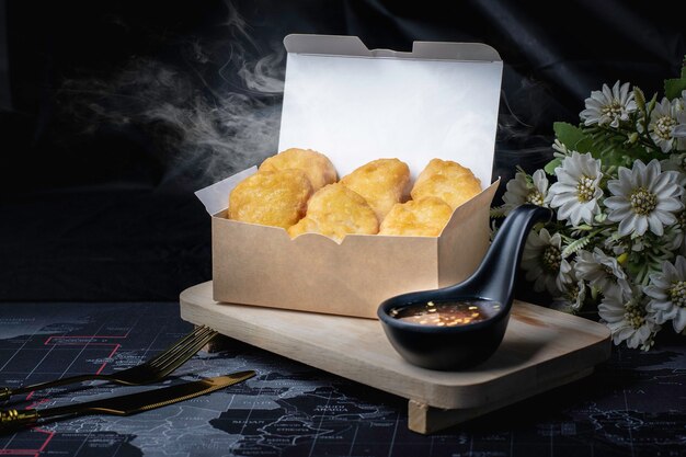 Chicken nuggets. Fried food with golden yellow color. Black background.