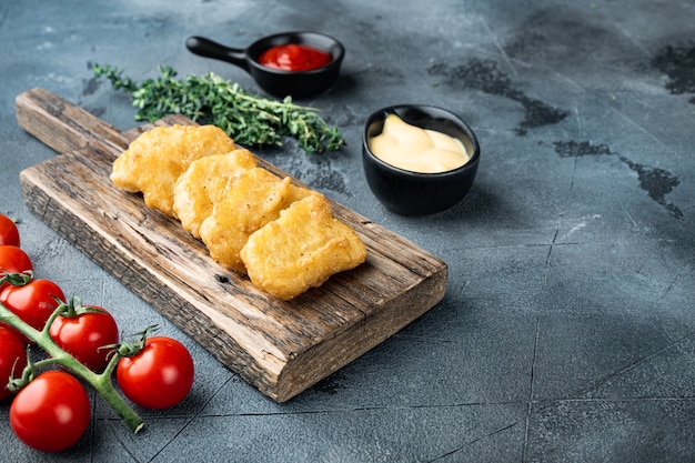 Chicken nuggets fried on grey table,.