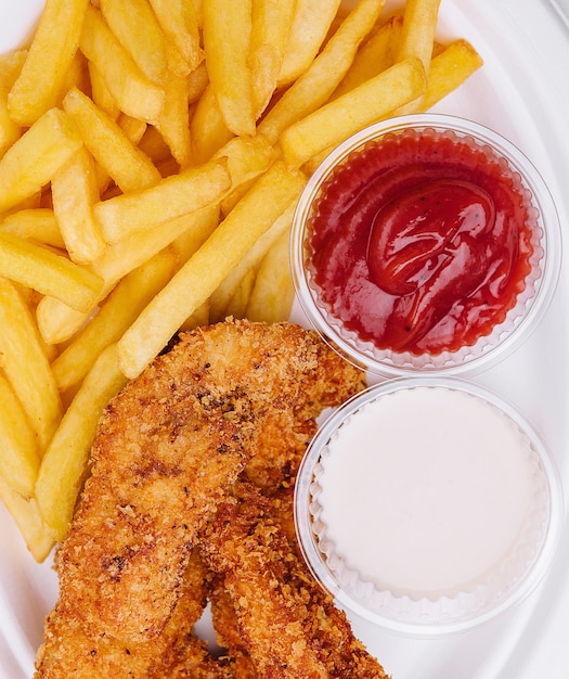 Chicken nuggets with french fries top view