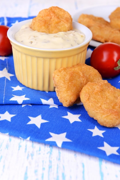 Chicken nuggets with sauce on table closeup