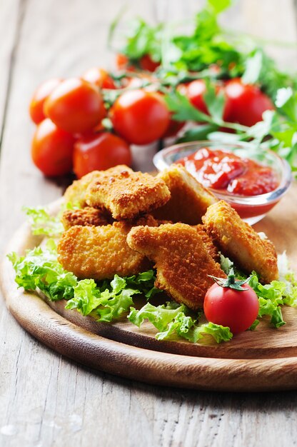 Chicken nuggets on the wooden table