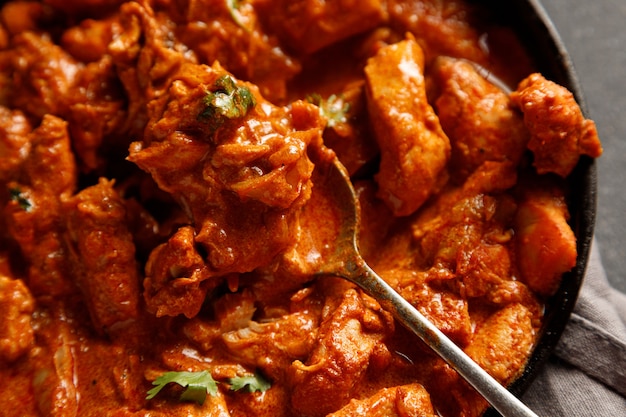 Chicken paprikash dish with paprika onion bulgarian paper on pan on dart table for dinner