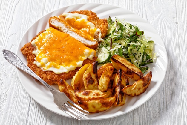 Chicken parmo with coleslaw and roast potatoes