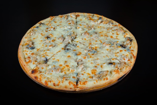 Chicken pizza with cheese and corn pieces on a black background