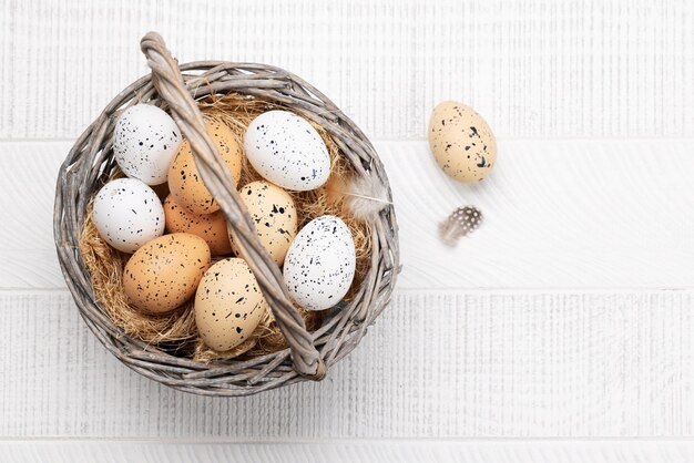 Chicken and quail eggs in basket