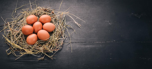 Chicken raw brown eggs On a wooden background Top view Copy space