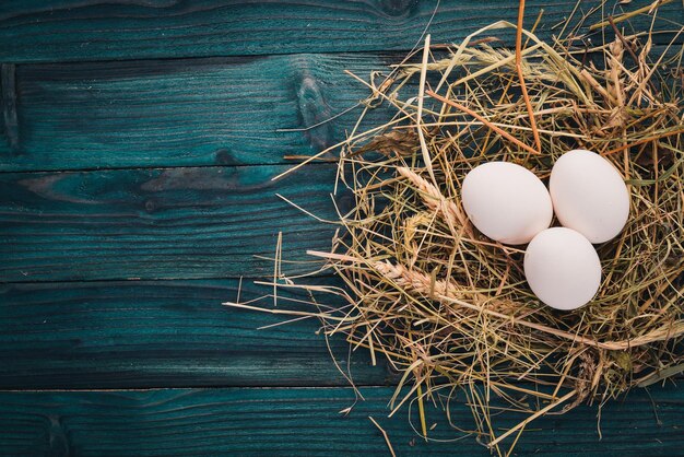 Chicken raw white eggs On a wooden background Top view Copy space